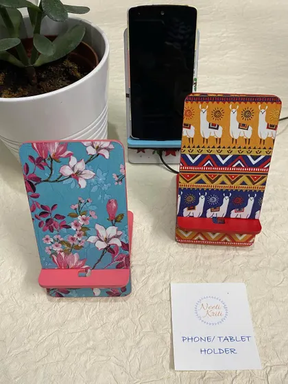 A floral print and a llama print phone stand, showing the variety of designs available.