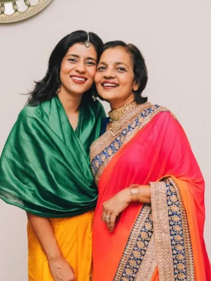 Another precious photo with my mom. Her elegant saree and my vibrant green and yellow outfit reflect our shared love for color and dressing up.