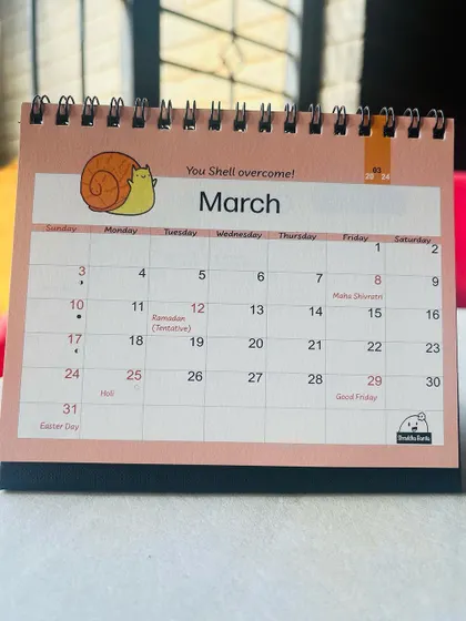 The March 2024 calendar page, with its cheerful snail and pastel pink color scheme.