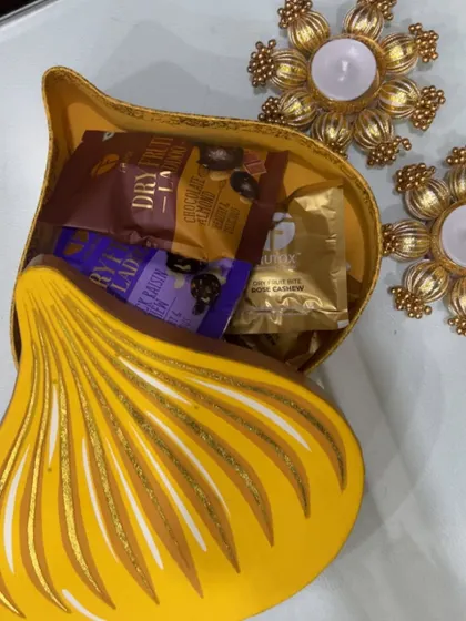 A look inside the modak-shaped box, filled with healthy dry fruit laddoos and other assorted treats.