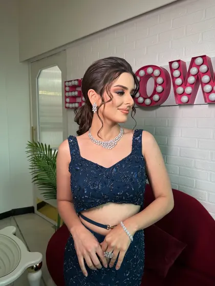 A side profile showcasing the elegant, messy ponytail we created for her cocktail night. The hairstyle is designed to be both chic and comfortable, allowing for movement while staying perfectly in place.