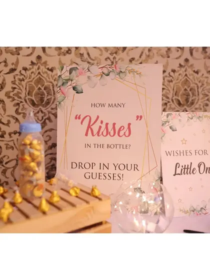Fun and games for everyone! We set up a "How many kisses in the bottle?" guessing game and a "Wishes for the Little One" station for guests to participate in.