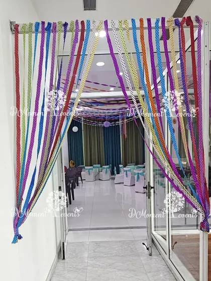 A creative entrance using colorful ribbons to create a curtain, welcoming guests into the craft-themed celebration.