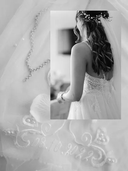 A creative detail shot showing the wedding date embroidered on the bride's veil, a personal and unique touch.