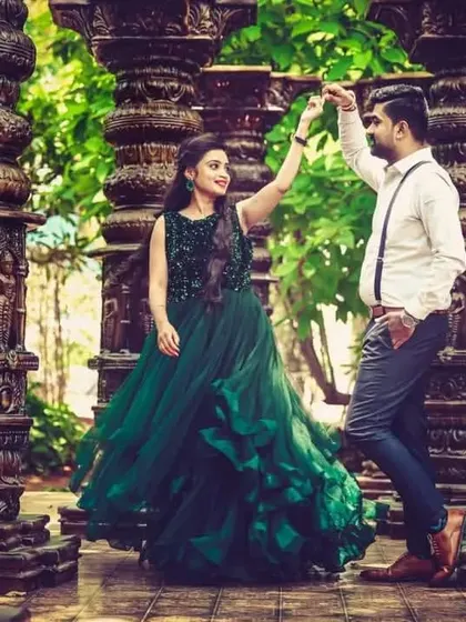 A dance pose from a pre-wedding shoot in a dramatic, rustic location. I provided this deep green ruffled gown and a smart casual look for the groom with suspenders.