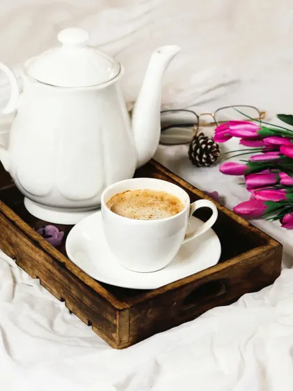 Another angle of the coffee tray, showing the elegant white teapot and cup. The soft, bright lighting gives the scene a peaceful and serene feeling.