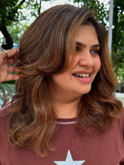 A happy client, travel-ready with her new hair.