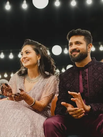 The bride and groom enjoying the performances at their Sangeet. I ensure there are comfortable and stylish seating areas for guests to relax and take in the show.
