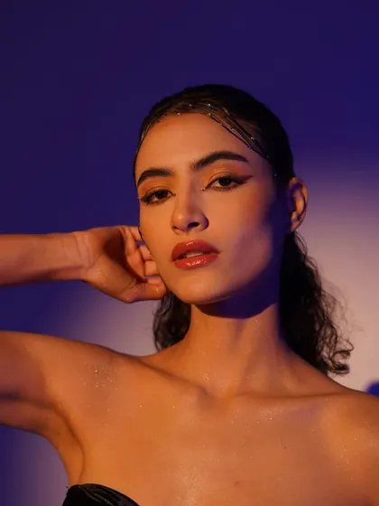 A direct and captivating portrait. The dual-tone lighting adds depth and dimension, making this a striking beauty or editorial shot.