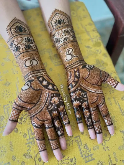 Another angle of the personalized engagement mehendi, showing the balance between the custom initials and the traditional lotus and check patterns.