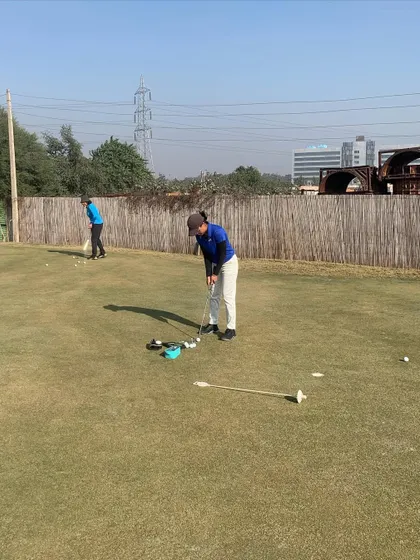 A player uses alignment aids to perfect her putting stroke on our new green, which is spacious enough for various training drills.
