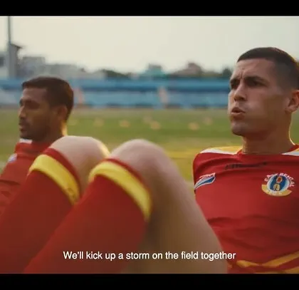 A close-up of the players training. The focus on their legs and the team-colored socks and jerseys adds to the authenticity of the sports film.