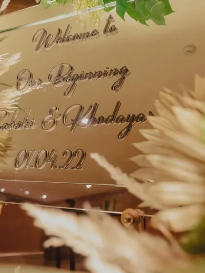 A close-up of the welcome mirror being prepped for a tropical-themed party.
