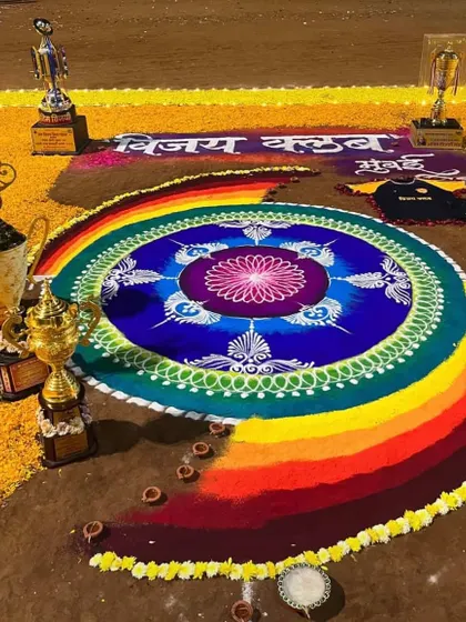 The vibrant colors of our Laxmi Pujan rangoli, surrounded by our championship trophies.