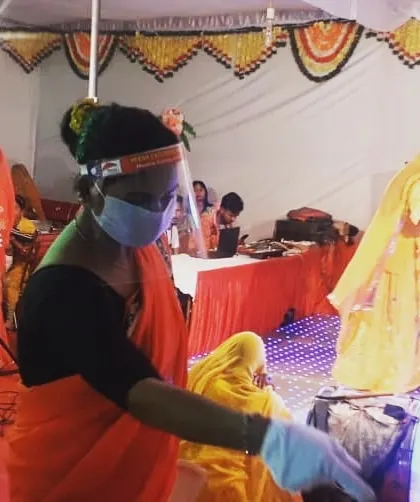 Safety and hygiene are our top priorities. Here, a member of our service staff at a Rajputana wedding in Pali wears a mask and face shield while serving guests.