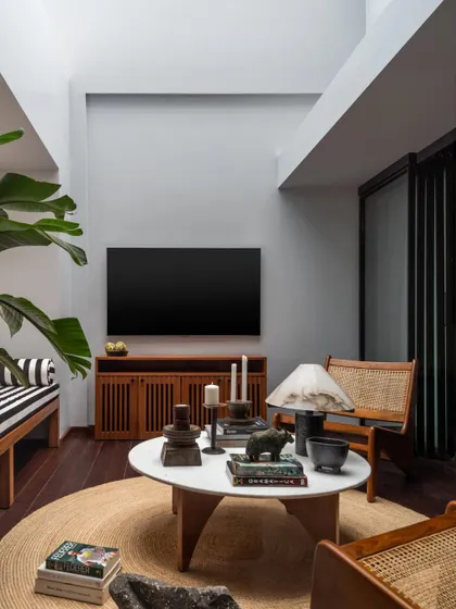This master bedroom lounge is situated in a double-height, sky-lit space, making it feel grand and airy. It serves as a private living room within the master suite, perfect for relaxation.