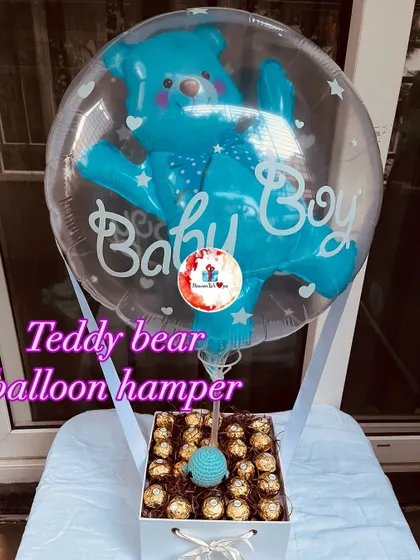 A "Baby Boy" announcement or baby shower gift. This hamper features a box of Ferrero Rocher chocolates topped with a blue teddy bear balloon.