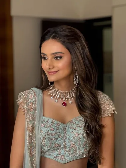 Another angle of the soft wave hairstyle, showing its timeless appeal and how it pairs perfectly with statement diamond jewelry for a regal look.