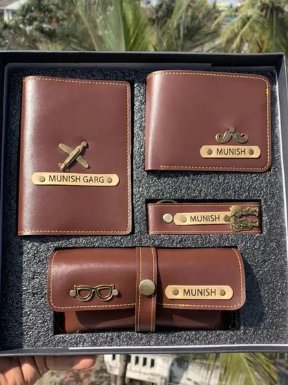 A complete 4-in-1 personalized travel essentials kit for him. This set includes a matching wallet, passport cover, keychain, and eyewear case, all customized with a name and charm.
