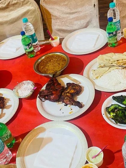 A typical place setting at one of our events. Guests are treated to a personal platter of starters, including green marinated fish and grilled chicken, along with fresh bread and curry.