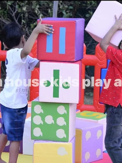 Two boys working together to build a tall tower with our soft, numbered blocks.