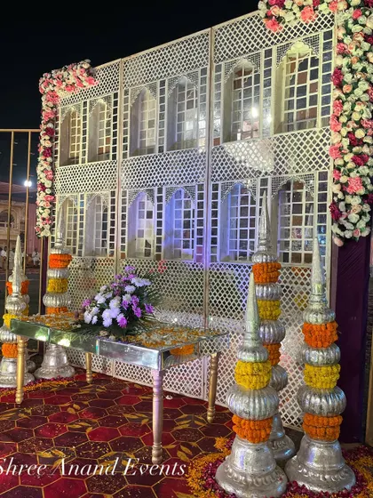 A beautiful backdrop inspired by traditional Rajasthani haveli architecture, complete with jharokhas and floral decorations.