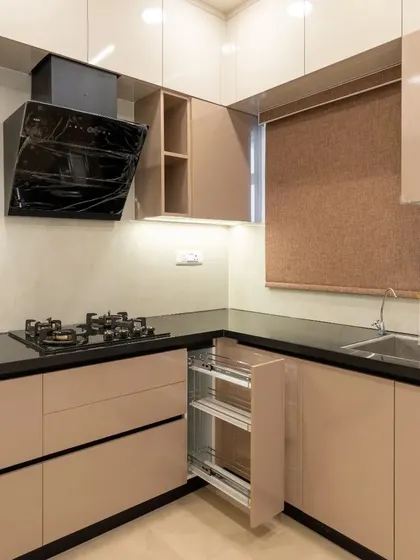 This shot highlights the smart storage solutions in the kitchen, including a pull-out spice rack, making organization effortless.