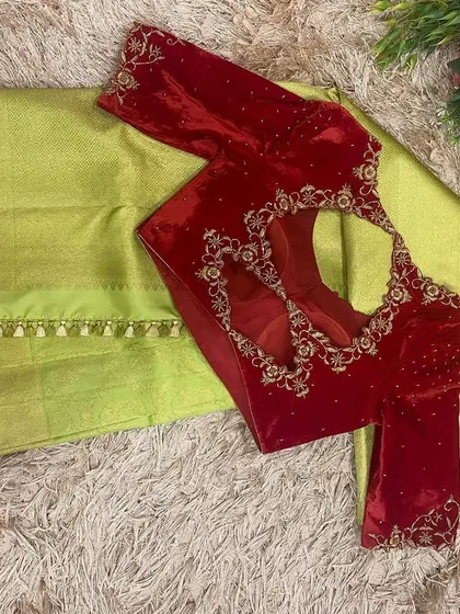 The back of the red velvet blouse, featuring a beautiful cutwork design outlined with hand embroidery.