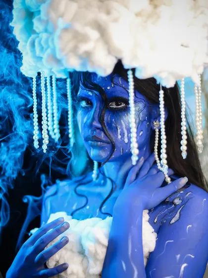 A creative and emotional look personifying a rain cloud, with blue body paint and "tears" of makeup.