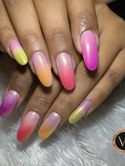 A different angle of our popular sunset ombré nails, showing the seamless blend of vibrant colors on long, oval-shaped extensions. The glossy finish enhances the beautiful color transition from every viewpoint.