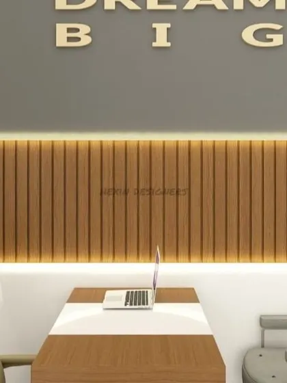 This executive office design balances professionalism with modern aesthetics. The fluted wood paneling with backlighting creates a warm focal point behind the desk, while the "Dream Big" lettering adds a motivational touch.
