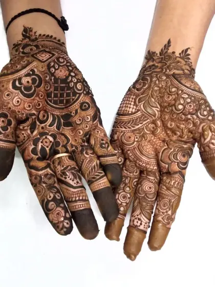 A clear view of a guest henna design, showing the combination of bold flowers and delicate filler patterns.