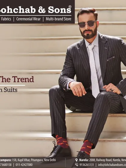Set your own trend with a stylishly fitted pinstripe suit. The modern cut and sharp tailoring make this a standout piece, showing how classic patterns can be adapted for a contemporary look.