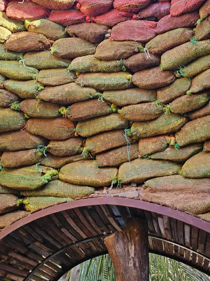 A detailed look at the interior of the earthbag dome. You can see how upcycled onion sacks are filled with earth and layered with barbed wire to create a strong, self-supporting structure.