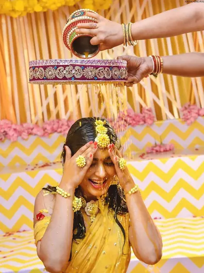 Capturing the pure joy of the Haldi ceremony. The bride is showered with flowers and turmeric, and my decor with its bright yellow drapes and floral accents creates a perfectly festive atmosphere.
