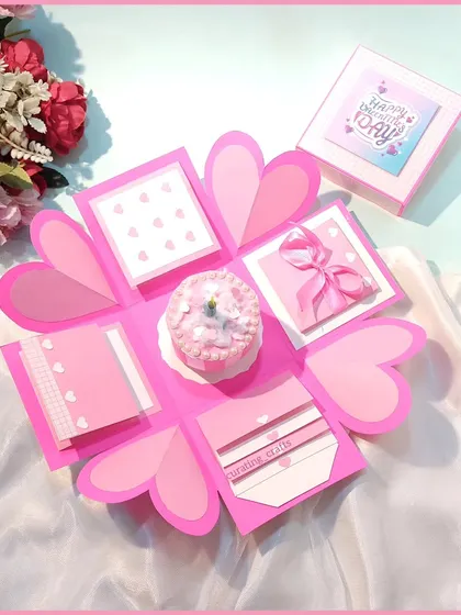 This is my classic heart-themed explosion box, opened up to show all its layers. It has space for messages, photos, and a small gift in the center, all wrapped up in a pretty pink design.