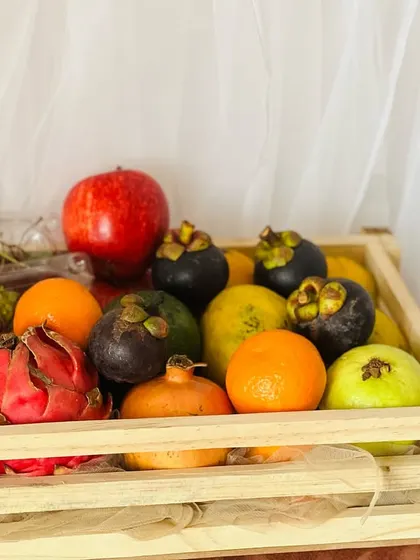 For a healthier option, I create fresh fruit baskets like this one. Packed in a rustic wooden crate, it’s full of colorful, seasonal fruits like dragon fruit, mangosteen, and pomegranate, making it a thoughtful wellness gift.