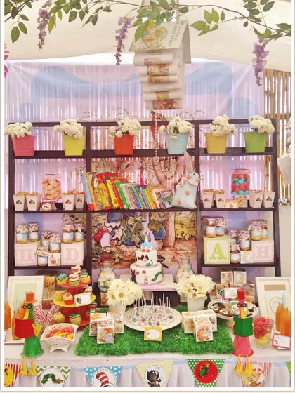 A unique "book library" themed baby shower. The dessert table was designed as a bookshelf filled with classic children's books and themed treats.