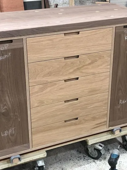 Here is the lower section of the drinks cabinet in my workshop before installation. You can see the solid wood construction, with oak drawer fronts and walnut cabinet doors, built upon a robust birch plywood frame.
