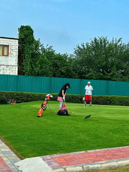 A junior golfer gets a lesson on the putting green. The focus and dedication start young here.