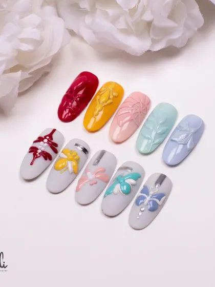 A collection of embossed designs featuring bows and other delicate patterns in a range of pastel and bold colors.