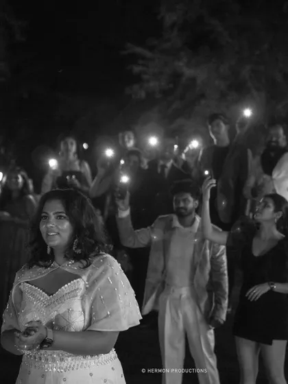 A beautiful black and white shot of the bride surrounded by the light from guests' phones, creating a truly memorable scene.