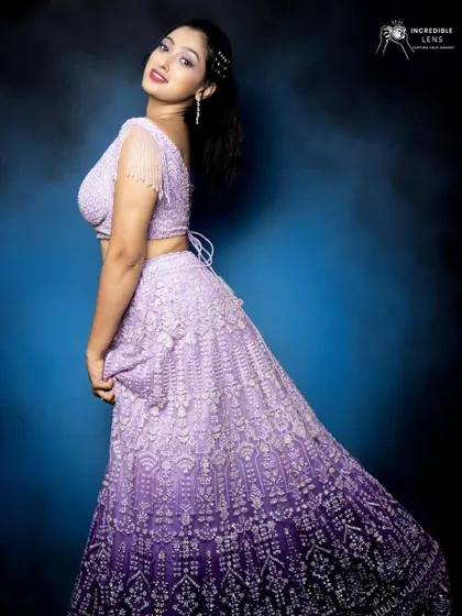 A full-length view of the stunning ombre purple lehenga. The makeup is designed to perfectly complement the shades of the outfit.
