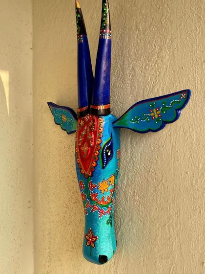 A beautiful Nandi in shades of blue, with delicate floral patterns and a striking red central motif.