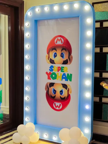 Another view of the personalized "Super Yohan" marquee sign. The bright lights and custom graphics create an exciting entrance for a video game-themed party.