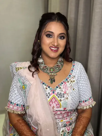 Her smile shows her confidence in the look. The makeup is glamorous yet feels light and comfortable.