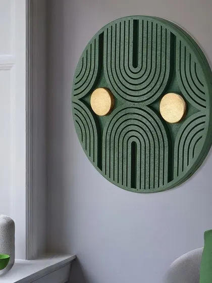 This lifestyle shot captures the green geometric art by a window, showing how the changing daylight interacts with its 3D surface.