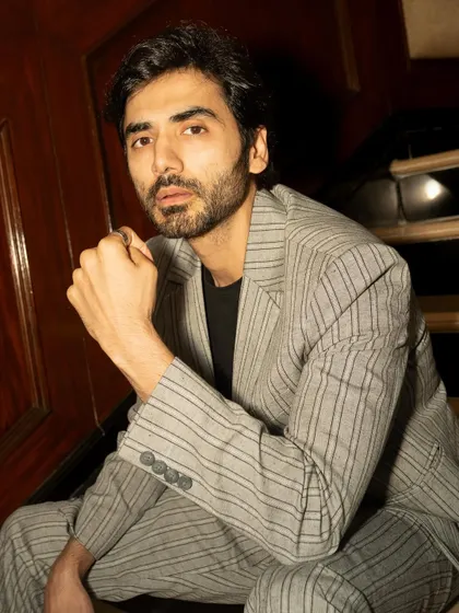 A close-up portrait of Ishwak Singh for GQ. The tight crop and direct gaze create an intimate and powerful image, perfect for an actor's feature.