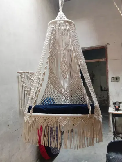 A beautiful sofa swing with a unique design, seen here in our workshop. This piece is ready to be shipped to a new home, bringing comfort and style.