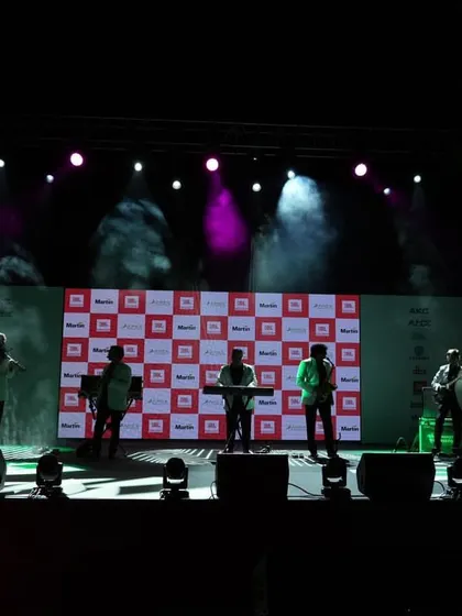 A live band performance under full stage lighting at a corporate event. We use professional lighting and effects to create a dynamic and engaging experience for attendees.